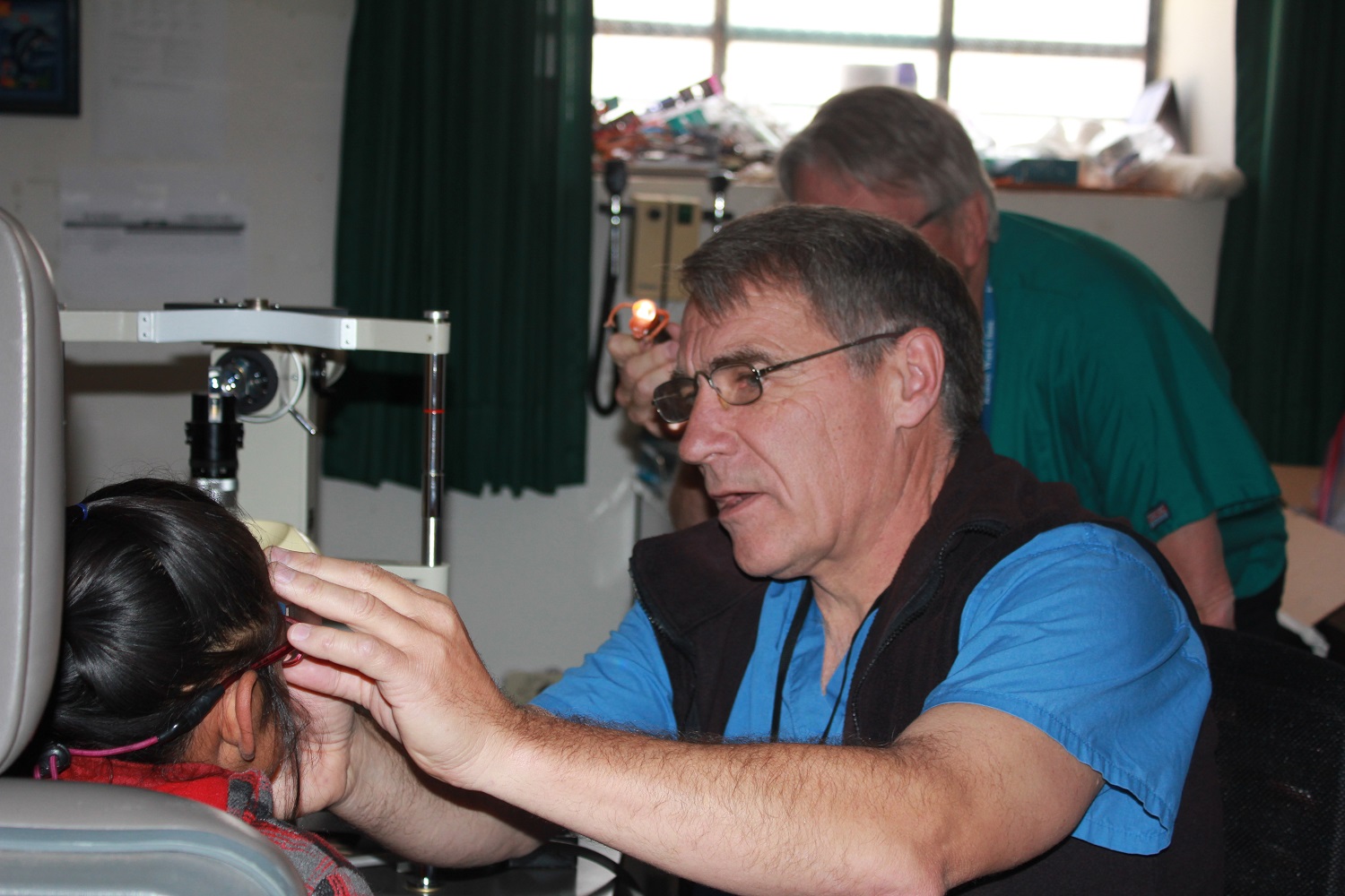 Dr. Paul Schultz Performing an Eye Exam on a Child